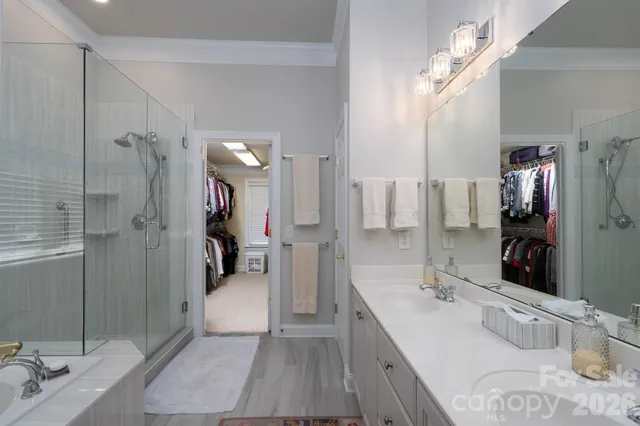 a bathroom with a double vanity sink mirror and shower