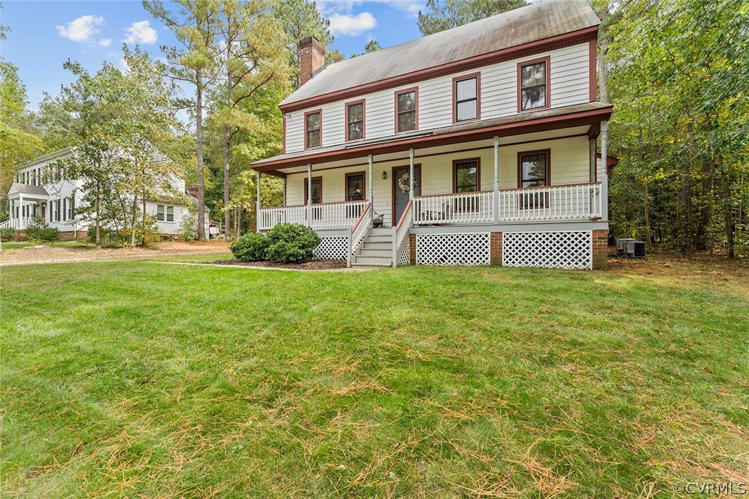 a front view of a house with yard and green space