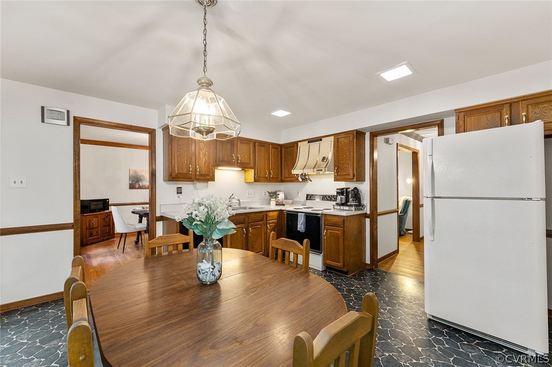 3601 Markey Road Midlothian, VA 23112 - Photo 13 of 33 a kitchen with a refrigerator a stove a sink dishwasher with a dining table and chairs