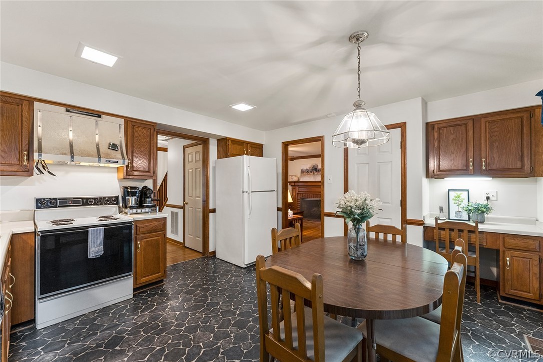 3601 Markey Road Midlothian, VA 23112 - Photo 14 of 33 a kitchen with stainless steel appliances granite countertop a stove a refrigerator a sink a dining table and chairs