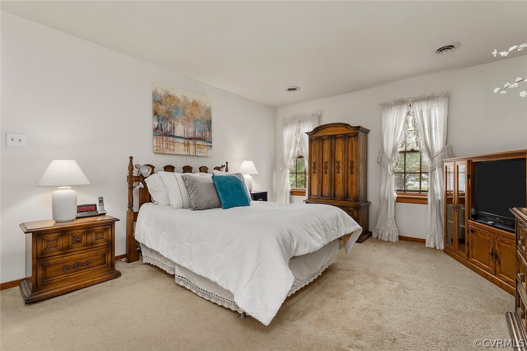 3601 Markey Road Midlothian, VA 23112 - Photo 19 of 33 a spacious bedroom with a bed and a flat tv screen on a dresser