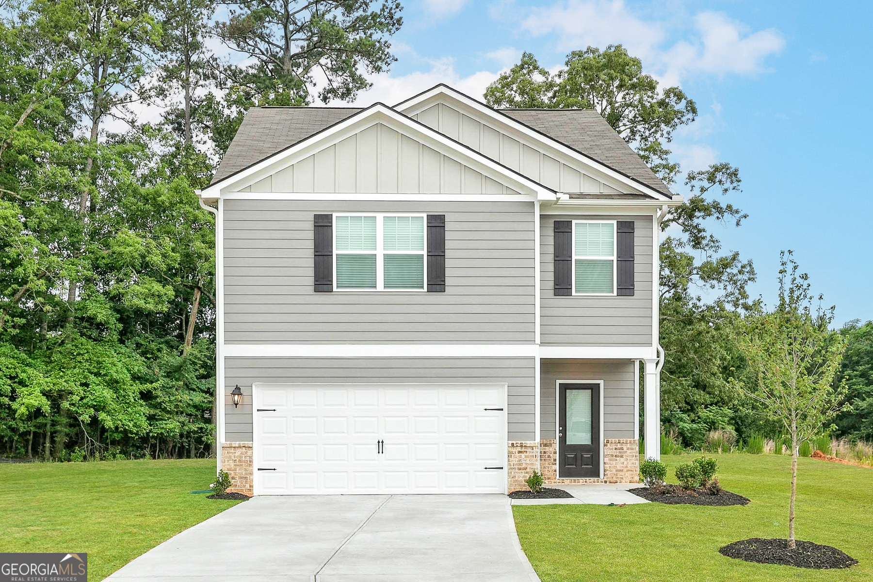 700 Plant Road Conyers, GA 30013 - Photo 1 of 1 a view of a white house next to a yard with big trees