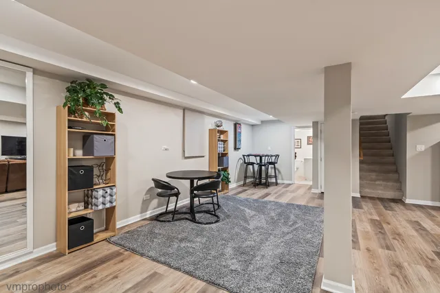 a living room with furniture a flat screen tv and a table