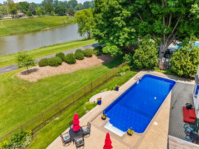 a view of a house with potted plants and a table and chairs