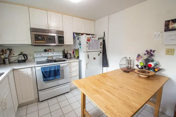 a kitchen with a sink a stove and cabinets