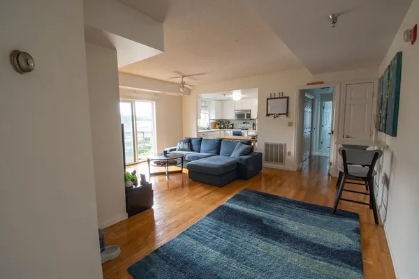 a living room with furniture and a wooden floor