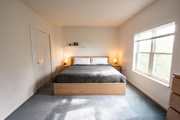 a bedroom with a bed and a window