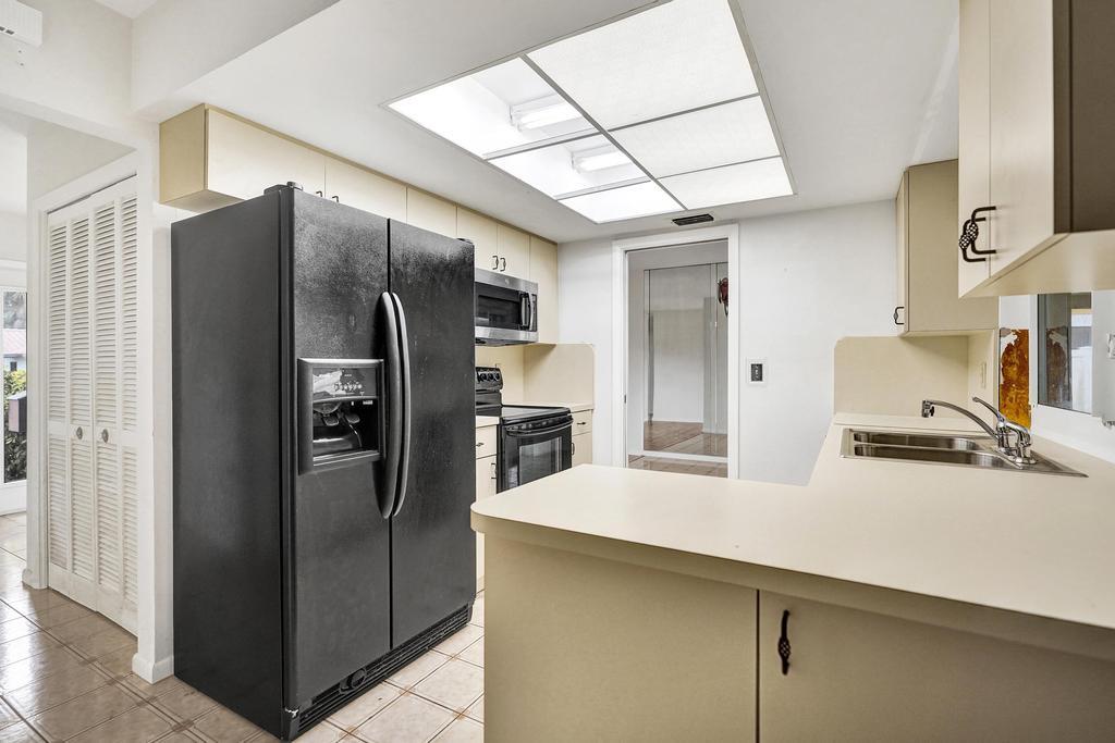 1236 Northwest 15th Street Boca Raton, FL 33486 - Photo 30 of 58 a kitchen with stainless steel appliances a refrigerator and a sink