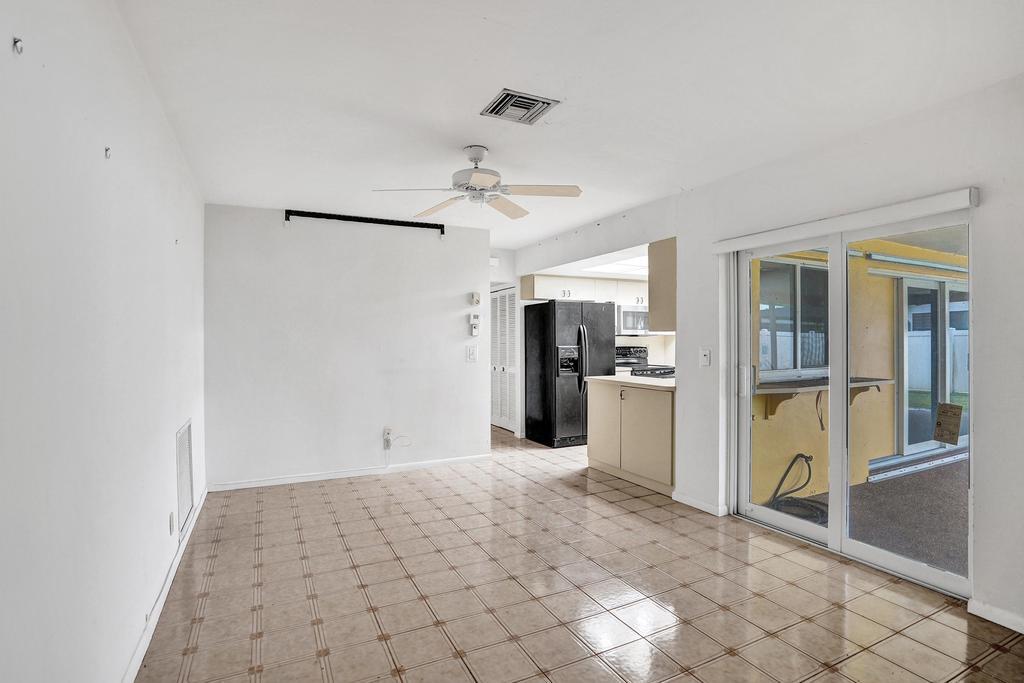 1236 Northwest 15th Street Boca Raton, FL 33486 - Photo 36 of 58 a view of a kitchen with refrigerator and a stove top oven