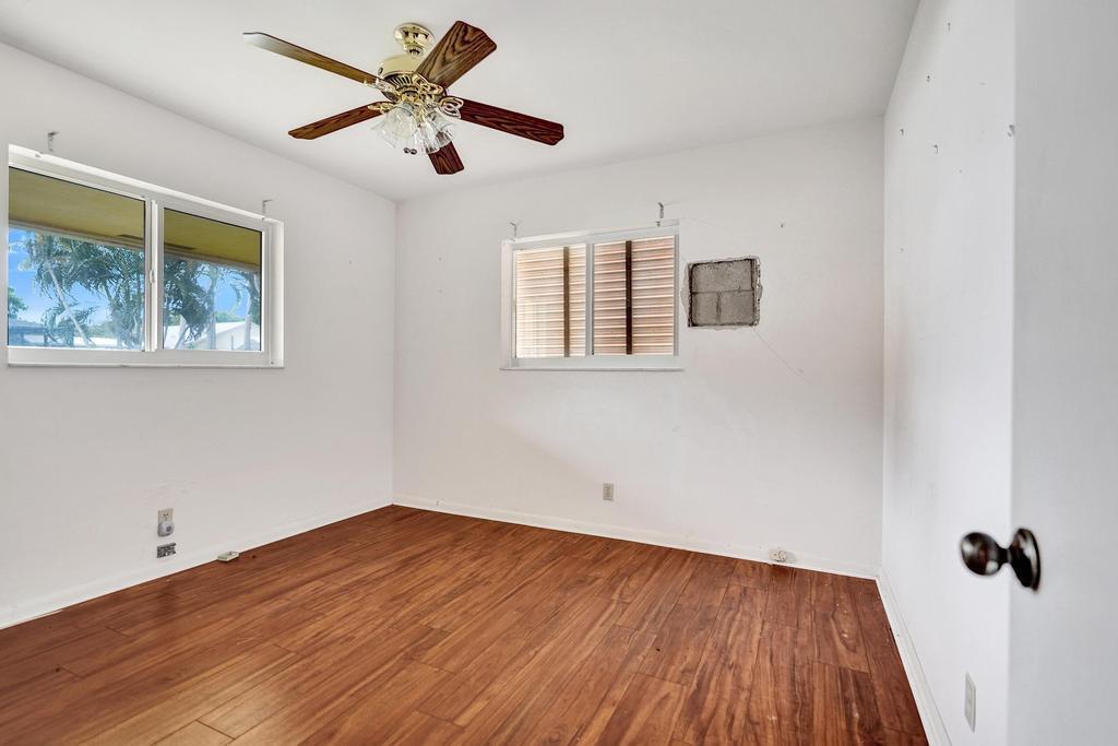 1236 Northwest 15th Street Boca Raton, FL 33486 - Photo 39 of 58 a view of empty room with wooden floor and fan