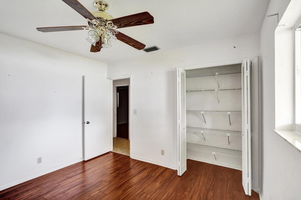 1236 Northwest 15th Street Boca Raton, FL 33486 - Photo 41 of 58 a view of an empty room with a window and wooden floor