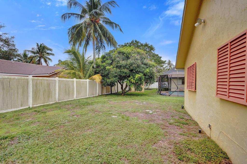 1236 Northwest 15th Street Boca Raton, FL 33486 - Photo 55 of 58 a view of a yard with yellow house