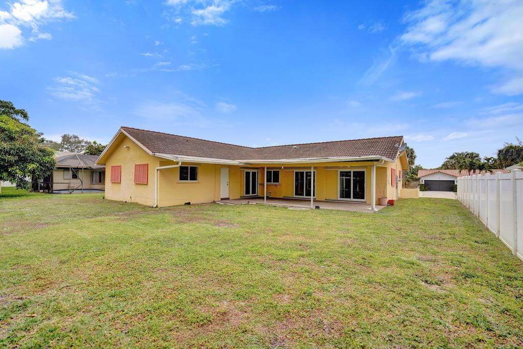 1236 Northwest 15th Street Boca Raton, FL 33486 - Photo 57 of 58 a house view with a garden space