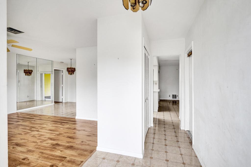 1236 Northwest 15th Street Boca Raton, FL 33486 - Photo 6 of 58 a view of a hallway with wooden floor and a living room