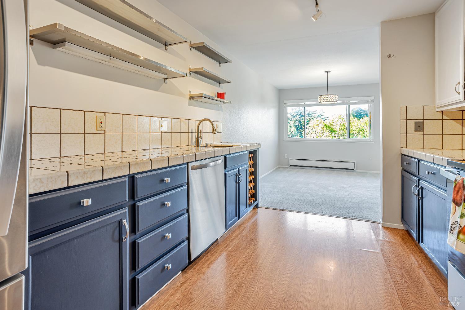 820 Mission Avenue, Unit 7 San Rafael, CA 94901 - Photo 13 of 34 a kitchen with stainless steel appliances a stove and a wooden floor