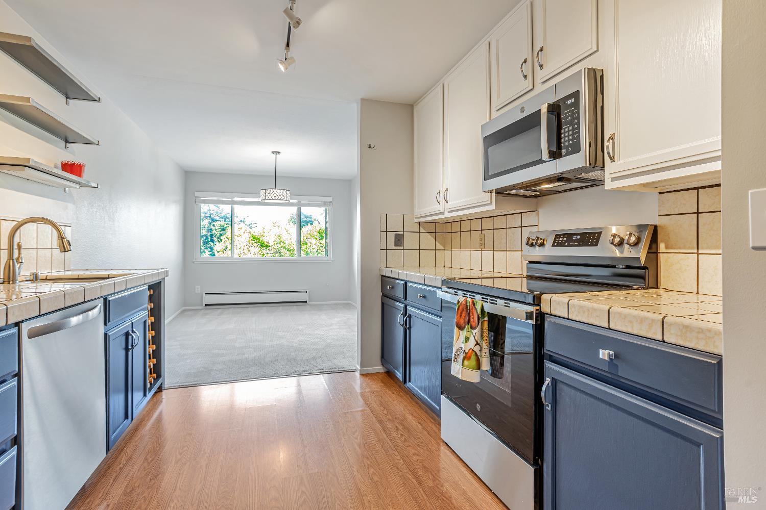 820 Mission Avenue, Unit 7 San Rafael, CA 94901 - Photo 13 of 33 a kitchen with stainless steel appliances granite countertop a sink stove and refrigerator