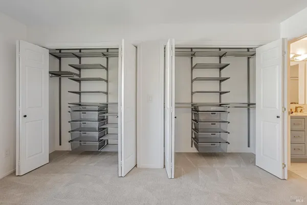 a view of walk in closet with empty racks