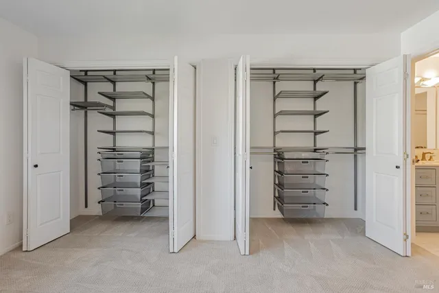 a view of walk in closet with empty racks