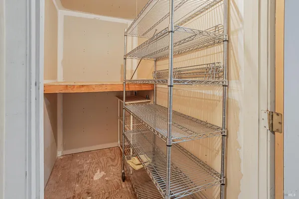 a view of walk in closet with empty racks