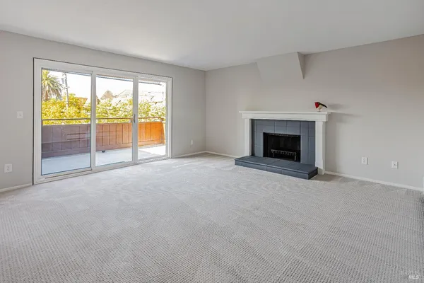 wooden floor fireplace and windows in an empty room
