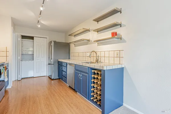 a kitchen view with wooden floor