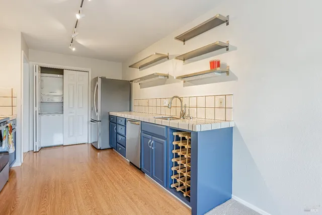 a kitchen view with wooden floor