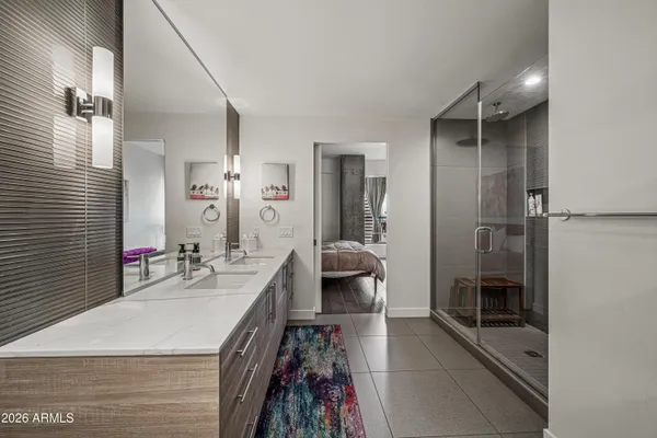 a bedroom with a bed and painting on the wall