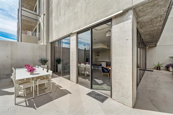 a swimming pool with outdoor seating and plants