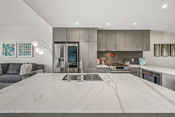 a large kitchen with a table and chairs