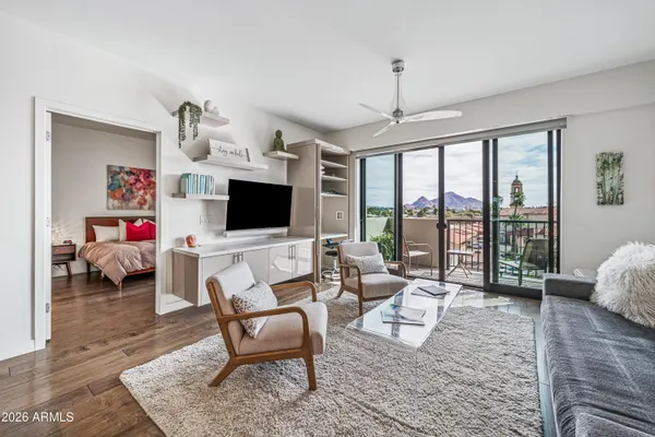 a view of a livingroom with furniture and a flat screen tv