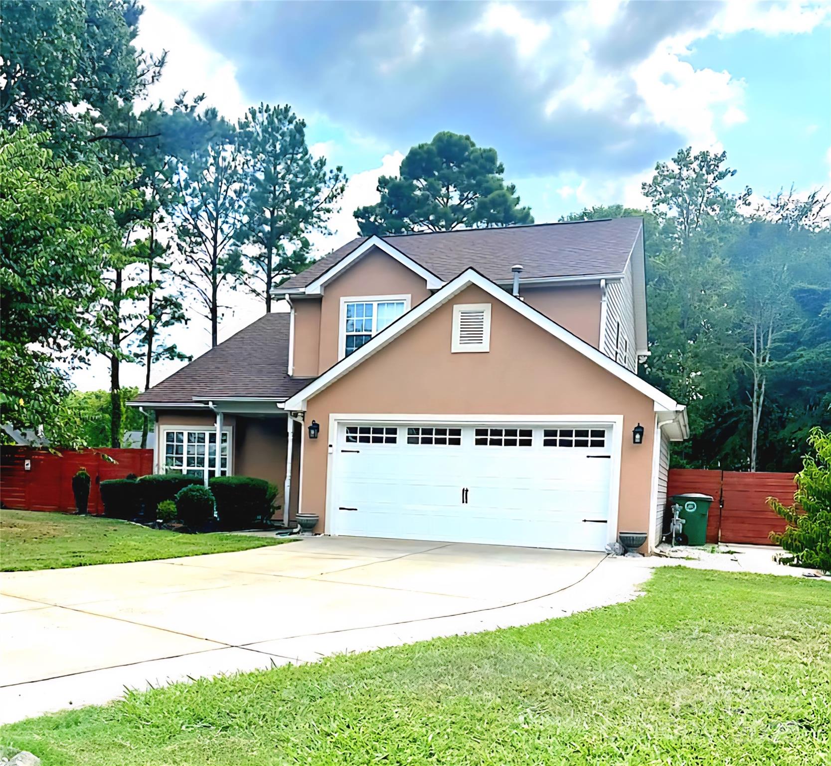 a view of a house with a yard and garage