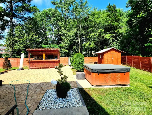 a backyard of a house with yard fire pit and outdoor seating
