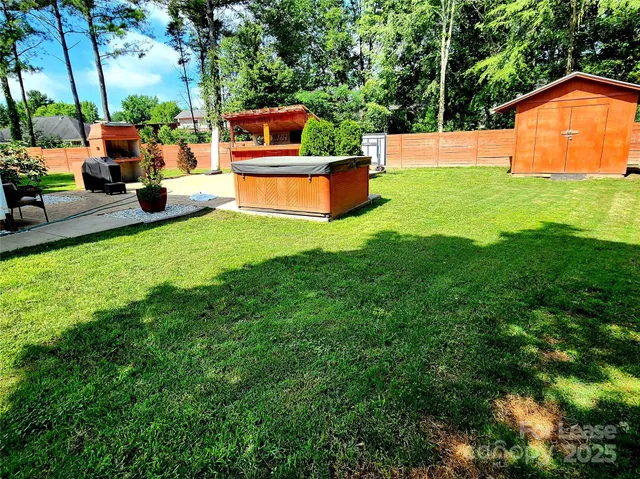 a backyard of a house with table and chairs
