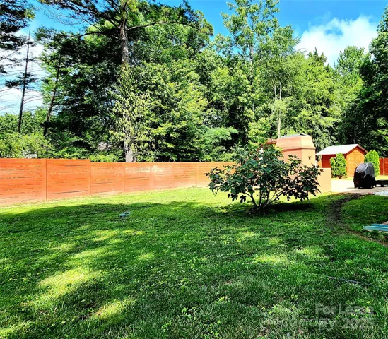 a view of a field of grass and trees