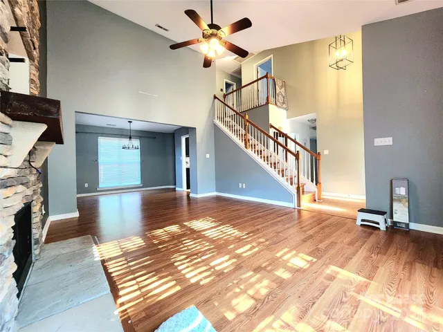 a view of a livingroom with wooden floor and a ceiling fan