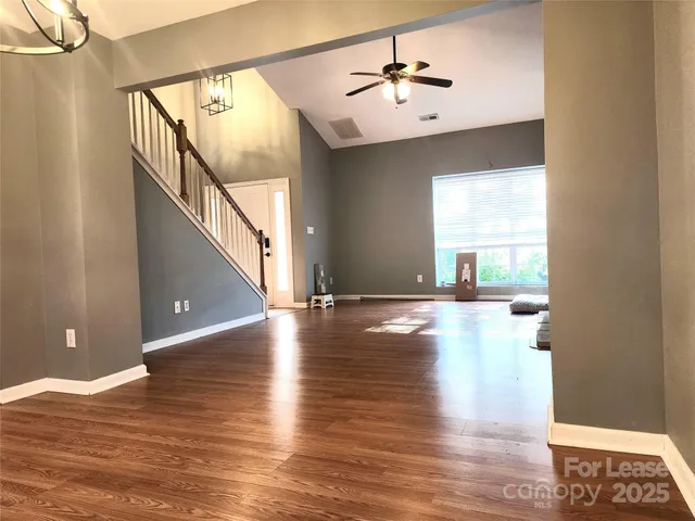 a view of a room with wooden floor and front door