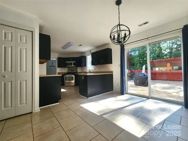 a kitchen with stainless steel appliances granite countertop a refrigerator a oven a sink and dishwasher