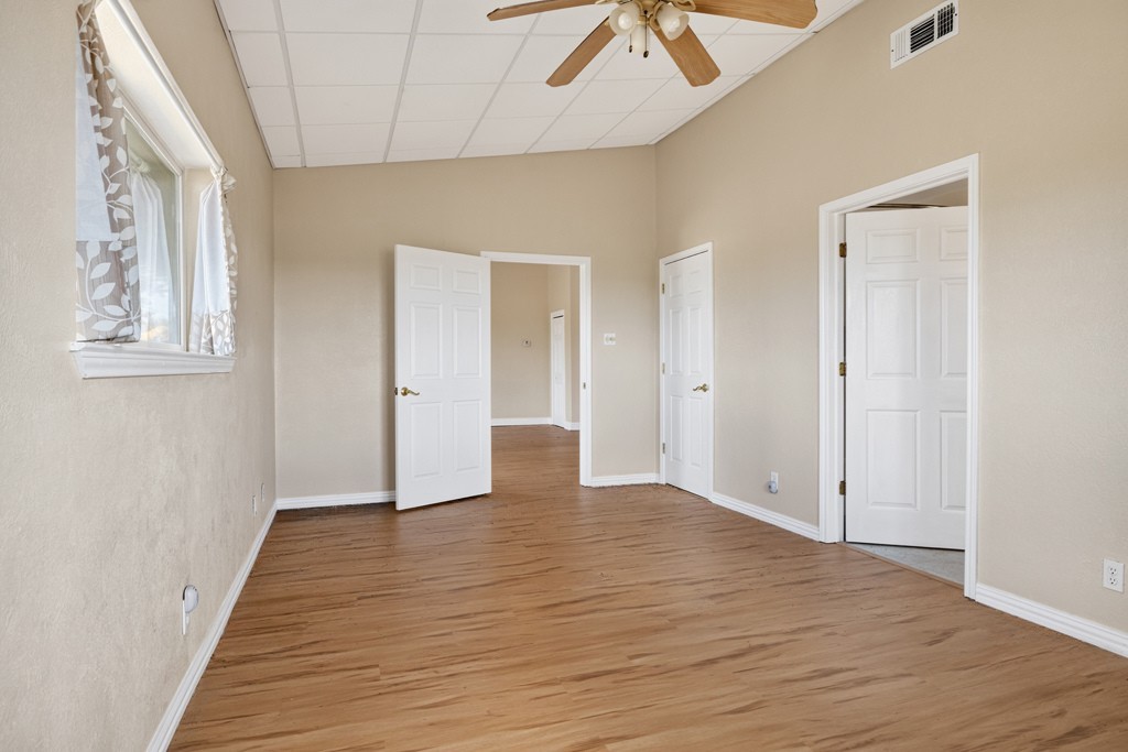 8804 Williamson Road Buda, TX 78610 - Photo 20 of 37 High vaulted ceilings and wood-style flooring elevate this versatile interior space.