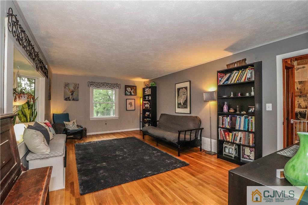 31 Silvers Road Freehold, NJ 07728 - Photo 11 of 46 a living room with furniture a bookshelf and a window