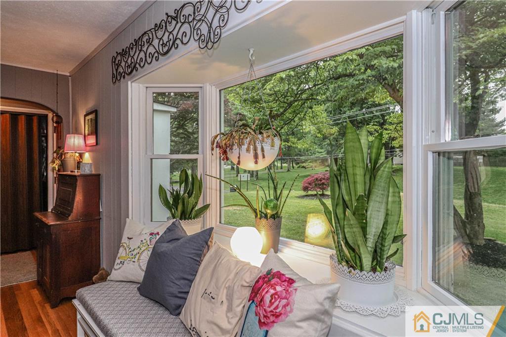 31 Silvers Road Freehold, NJ 07728 - Photo 13 of 46 a living room with patio furniture and a floor to ceiling window