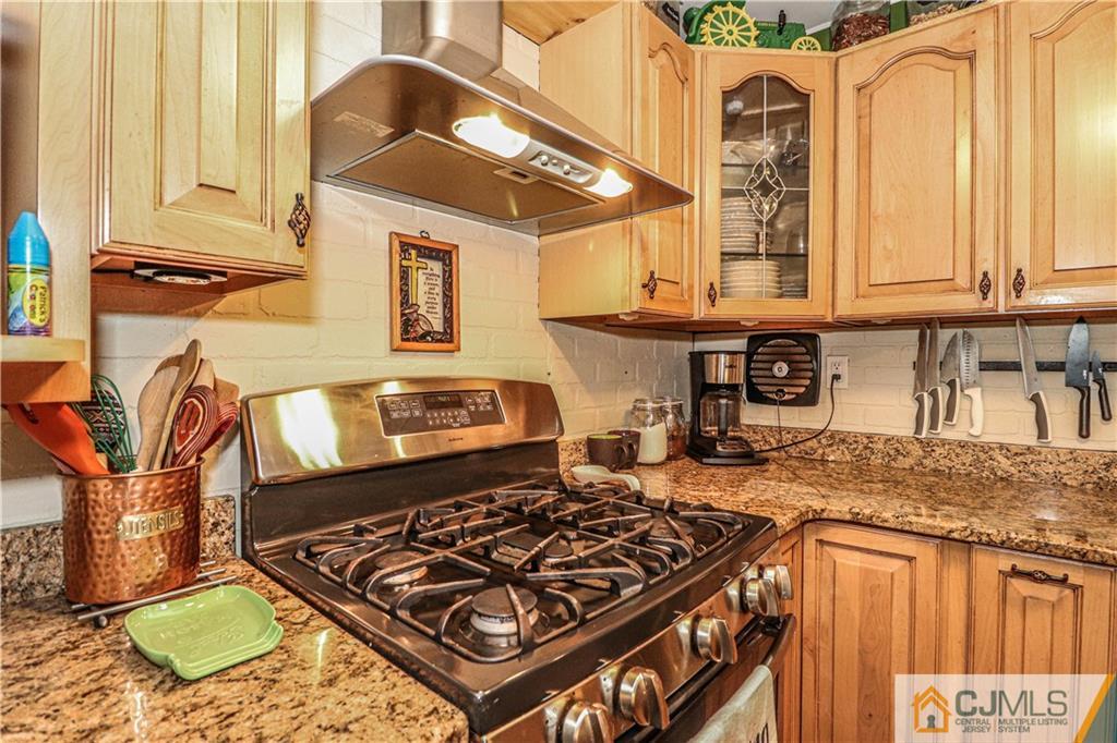 31 Silvers Road Freehold, NJ 07728 - Photo 16 of 46 a kitchen with stainless steel appliances granite countertop a stove and a sink