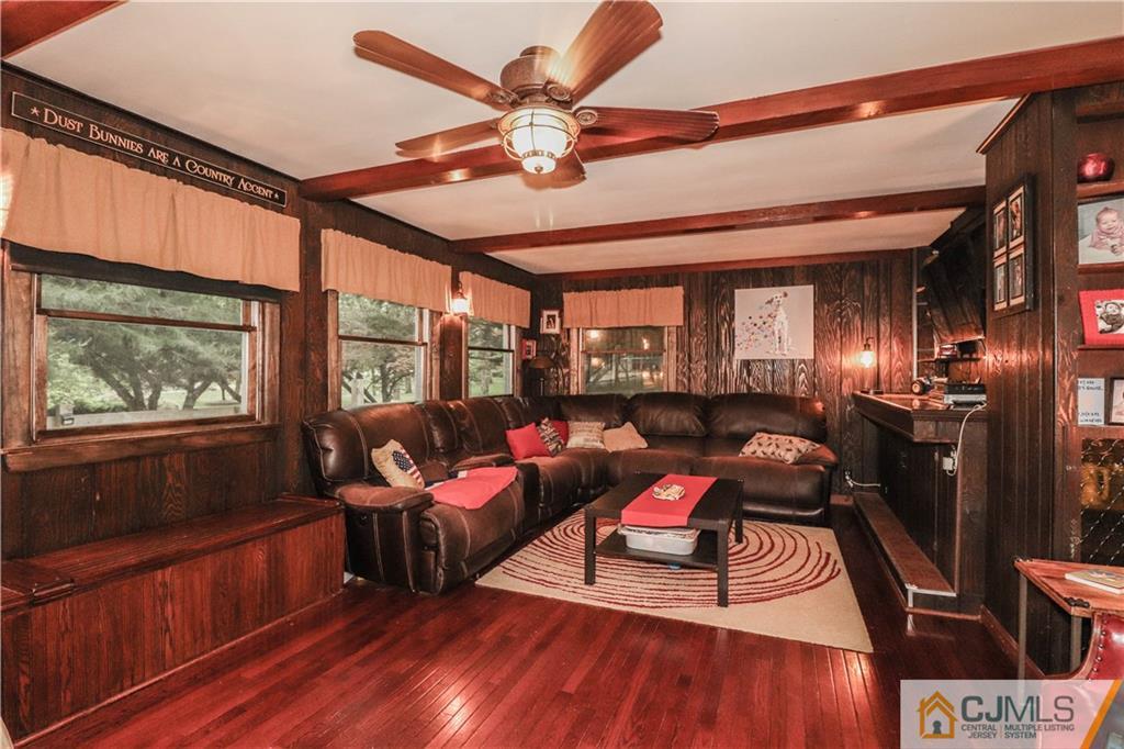 31 Silvers Road Freehold, NJ 07728 - Photo 21 of 46 a living room with furniture a wooden floor and a large window