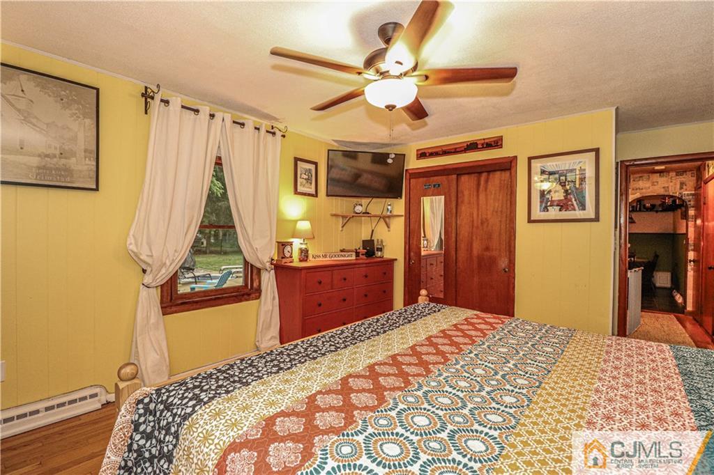 31 Silvers Road Freehold, NJ 07728 - Photo 23 of 46 a bedroom with a bed and a chandelier