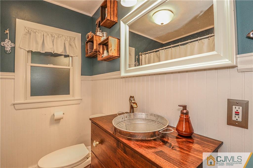31 Silvers Road Freehold, NJ 07728 - Photo 33 of 46 a bathroom with a toilet sink and mirror