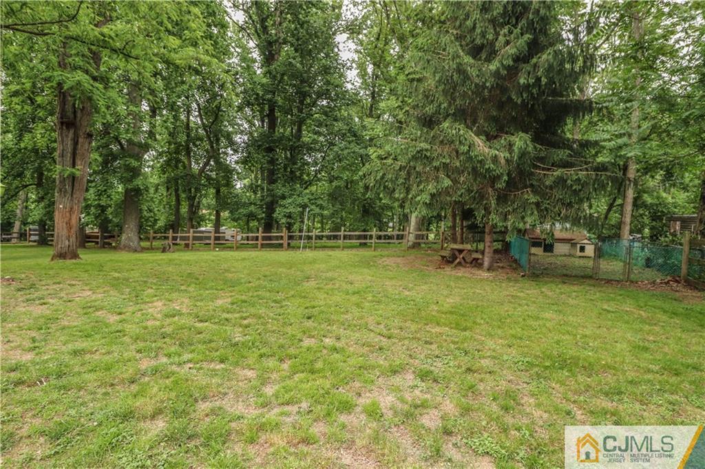 31 Silvers Road Freehold, NJ 07728 - Photo 45 of 46 a backyard of a house with lots of green space and fountain