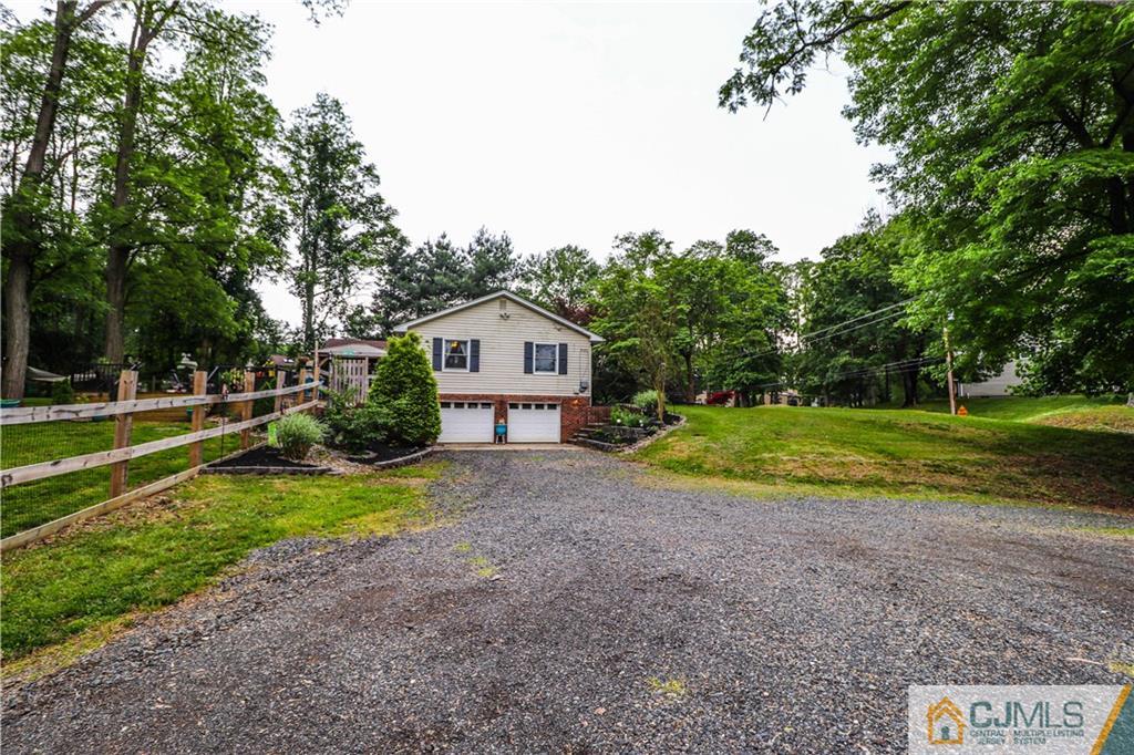 31 Silvers Road Freehold, NJ 07728 - Photo 8 of 46 a front view of a house with a yard and garage