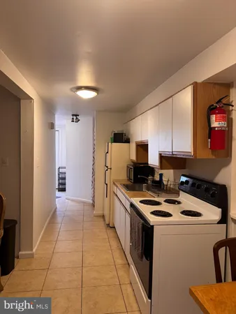 a kitchen that has a sink and a stove top oven