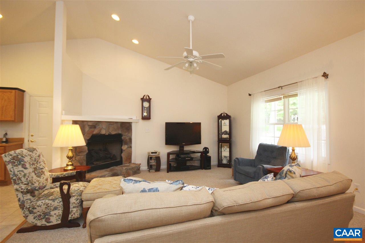 11 Zephyr Road Palmyra, VA 22963 - Photo 6 of 21 a living room with furniture a fireplace and a flat screen tv