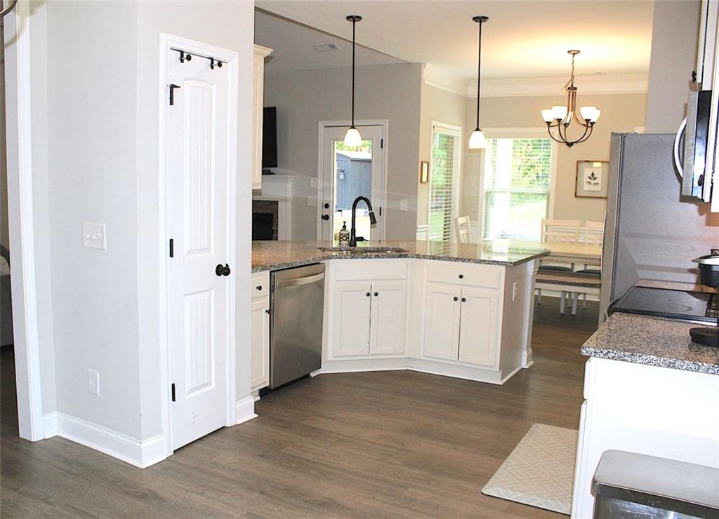 728 Harmony Road Temple, GA 30179 - Photo 11 of 29 a large kitchen with white cabinets and stainless steel appliances