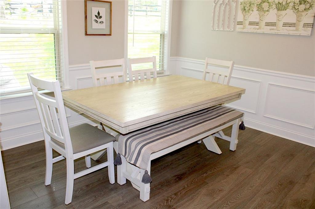 728 Harmony Road Temple, GA 30179 - Photo 12 of 29 a view of a dining room with furniture and wooden floor